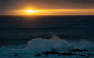 Sunset ocean wave rock person - a sunset over the ocean free wallpaper