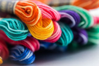 Yarn closeup table spool thread - a cross stitch free wallpaper