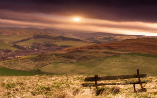 Hillside bench grass cloudy sunset - top of a grass free wallpaper