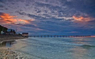 Sunset pier beach waves cloudy - a pier free wallpaper for desktop