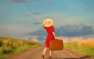 Woman red dress hat suitcase - liminal space free wallpaper