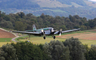 Small plane green field mountain - the background and a mountain in the distance free wallpaper