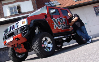 Man red truck monster tire - a monster truck free wallpaper for desktop