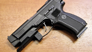 Black gun wooden table vector - free technology wallpaper