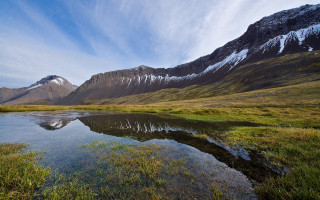 Mountain lake grassy field snowy 2 - a grassy field in the foreground free wallpaper