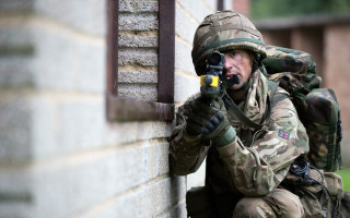 Soldier aiming gun outside military - a soldier free wallpaper