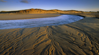 River beach mountains sky ocean - a sandy beach next free wallpaper