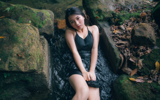 Woman sitting rock waterfall blackdress - a black dress and heels free wallpaper