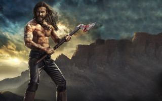 Bearded warrior axe mountain fantasy - his hand and a mountain in the background free wallpaper