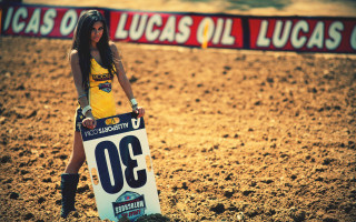 Woman yellow shirt sign dirtfield - a banner in the background free wallpaper