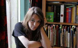 Woman leaning on shelf bookcase - a bookcase free wallpaper