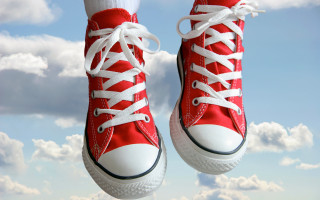 Red converse shoes jumping blue - white cloud free wallpaper