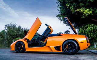 Bright orange sports car open 3 - a street corner free wallpaper