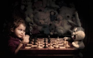 Little girl playing chess stuffed - a chess board free wallpaper