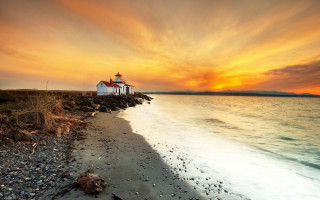 Lighthouse rocky shore sunset ocean 4 - a colorful sky above free wallpaper