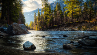 River rocks trees mountain sky 2 - the background and a mountain in the distance free wallpaper
