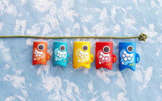 Colorful toothbrushes hanging blue clouds - a blue surface free wallpaper for desktop