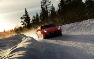 Red sports car snowy road 2 - a snow free wallpaper