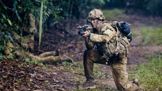 Camouflage man crouching camera forest - colin hayes free wallpaper