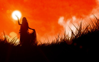 Woman sunset field fire embers - a red sky in the background free wallpaper for desktop