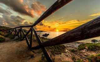 Wooden railing beach sunset clouds - constantine andreou free wallpaper