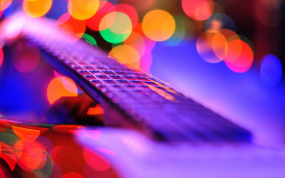 Guitar neck bokeh lights funk - a close up of a guitar neck free wallpaper