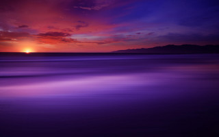 Sunset water mountain purple sky - a sunset over a body of water free wallpaper