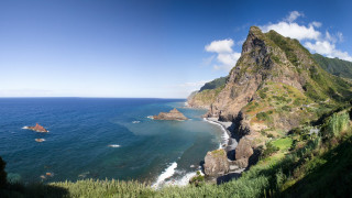 Beach mountain scenery boat horizon - the foreground and a boat in the distance free wallpaper