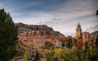 Village clocktower hillside mountains trees - a village free wallpaper for desktop