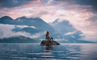 Woman lake rock mountains clouds - eva frankfurther free wallpaper