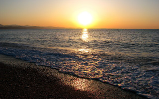 Sunset ocean waves mountain city - a mountain in the distance free wallpaper