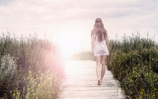 Woman walking flower field sunset - liminal free wallpaper