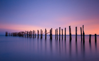 Poles water sunset purple sky - a purple sky in the background free wallpaper