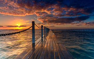 Sunset dock water clouds cityscape - a wooden dock free wallpaper for desktop