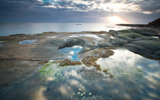 Rock formation hole water sun - a rock formation free wallpaper