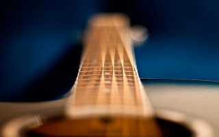 Guitar neck blurry background bokeh - a close up of a guitar neck free wallpaper
