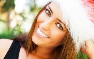 Woman santa hat smiling wind - a santa hat free wallpaper