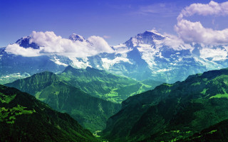 Mountain range green hills clouds - a view of a mountain range free wallpaper
