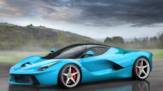 Blue sports car wet road 2 - the background and a mountain in the distance free wallpaper