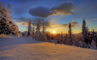 Sunset snowy mountain trees clouds 3 - a sunset over a snowy mountain free wallpaper