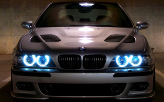 Silver car lights on parking - a concrete wall behind free wallpaper