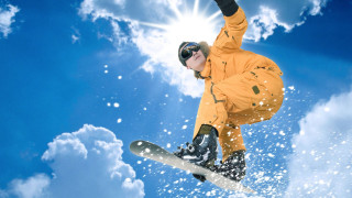 Snowboarder orange jacket air trick - a snowboarder free wallpaper