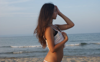 Woman bikini beach ocean horizon - her right hand free wallpaper