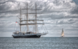 Large boat sailing ocean cloudy - under free wallpaper