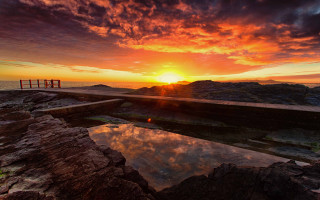 Rocky beach sunset ocean lighthouse - a rocky beach next free wallpaper