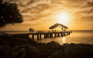 Pier thatched roof sunset people - sunset time free wallpaper for desktop