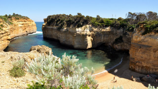 Beach cliff water bridge sky - a cliff and a body of water free wallpaper