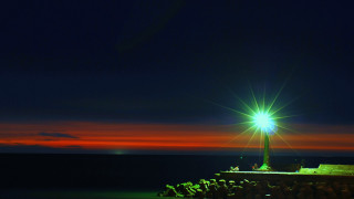 Lighthouse brightlight nighttime redsky anamorphic - a red sky in the background free wallpaper for desktop
