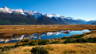 Mountain river grass field trees - a grassy field in the foreground free wallpaper