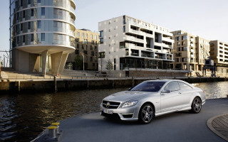 Silver car road water buildings - the other side of the road free wallpaper